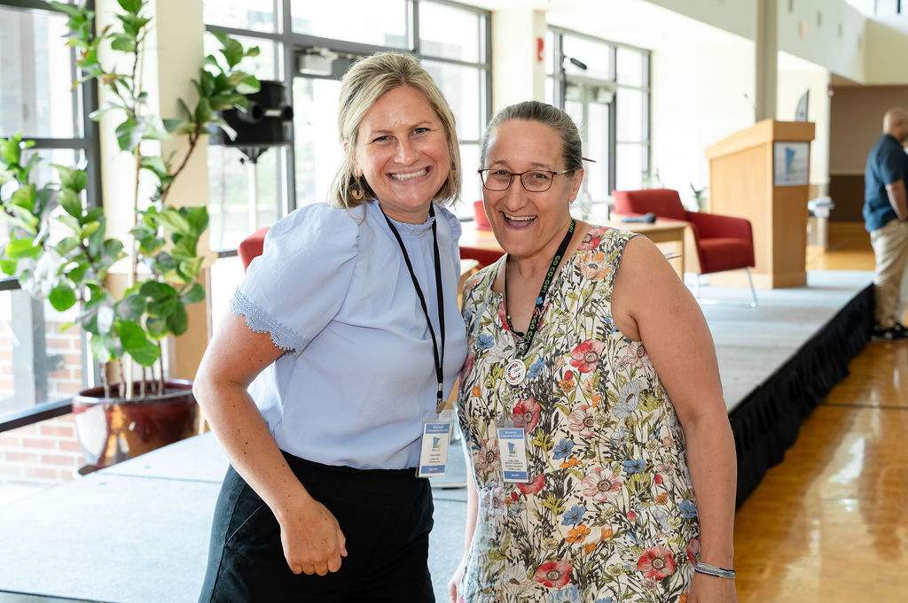 Katie and another attendee smiling together at the Minnesota Cooperative Summit.