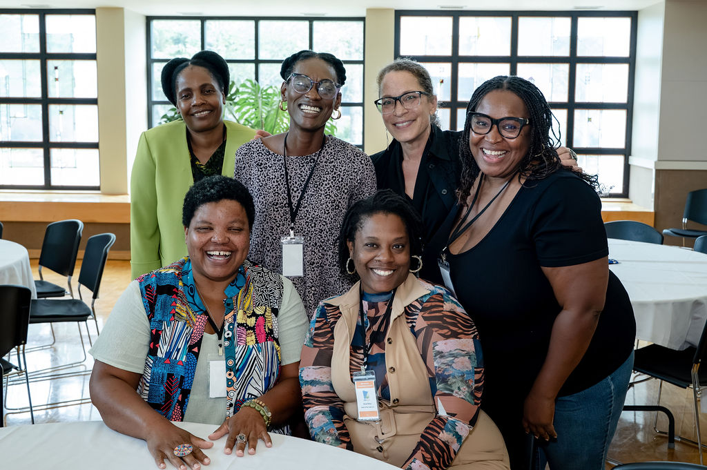 Six Minnesota Cooperative Summit attendees smiling together.